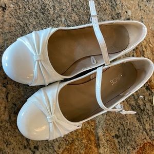 White patent leather kids heels.